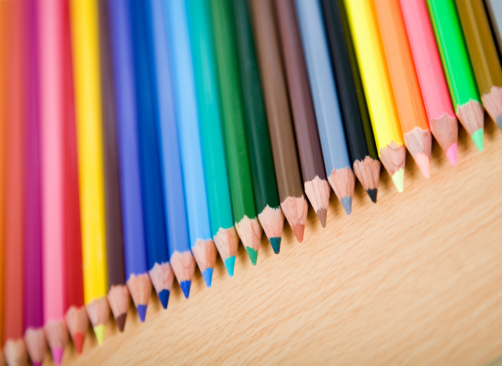 color pencils over a wooden surface in a perspective angle